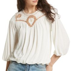 An Embroidered Front Yoke With A Mesh Overlay Delicately Defines This Seersucker Constructed Blouson Top. It Has Scoop Neck With Ruffle Trim, Long Sleeves With Elasticized Cuffs, Smocked Back Yoke, And Blouson Construction With Elasticized Hem Lined In The Bodice. Brand: Free People Material: Shell: 83% Viscose, 17% Linen Lining: 100% Viscose Cleaning: Machine Wash Color: Sand Cream Size: Medium Measurements: Bust - 38" Length - 22" Cream Cotton Top With Floral Embroidery, Casual Embroidered Off White Tops, Beige Floral Embroidered Cotton Tops, Beige Cotton Top With Floral Embroidery, Spring Beige Embroidered Cotton Top, Cream Embroidered Cotton Tops, Fall Embroidered Crew Neck Top, Embroidered Off White Summer Tops, Off White Embroidered Summer Tops