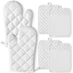 three oven mitts and two pot holders with tags on them, all in white