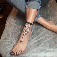 a woman's foot with a tattoo on it