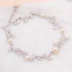 Our vine Crystal Bracelet is a perfect way to addto your wedding day jewelry featuring Swarovski crystals.    The CZ crystals are very high quality.  Set in a rhodium tarnish resistant base,  we have closed it with a lobster clasp and small extender complete with a matching crystal for final fit. Measurements: requested at checkout 💞 All our jewelry is presented in velvet pouches and high quality elegant, padded boxes ready for gifting 💝 ★Shopping for your bridal party? Contact us for special White Gold Crystal Bracelet For Wedding, Dainty Silver Crystal Bracelet For Wedding, Silver Cubic Zirconia Pearl Bracelet For Anniversary, Silver Pearl Crystal Bracelet For Wedding, White Crystal Diamond Bracelet For Wedding, Dainty Cubic Zirconia Crystal Bracelet For Wedding, Dainty Crystal Bracelet For Wedding, Silver Cubic Zirconia Bracelet For Bridesmaid, Silver Dainty Wedding Bracelets