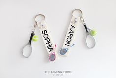 two key chains with tennis rackets hanging from them