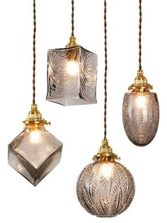 three glass hanging lights in different shapes and sizes