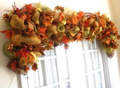 the wreaths are hanging on the window sill