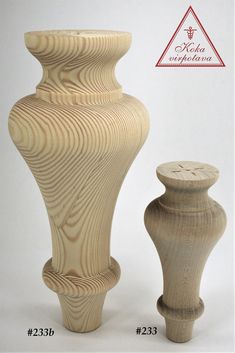 two wooden vases sitting next to each other on a white surface with a red triangle in the background