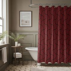 a bathroom with a bathtub, sink and shower curtain in red color on the wall