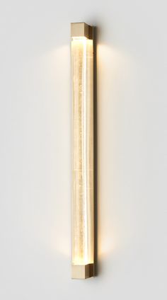 a light that is on the side of a wall with a long tube attached to it