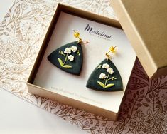 a pair of earrings in a gift box