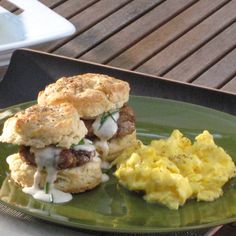 a green plate topped with biscuits and eggs