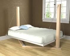 a bed that is sitting in the middle of a room with no sheets on it