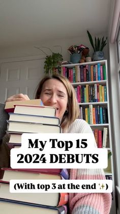 a woman holding a stack of books with the words my top 15 debuits