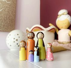 a group of wooden dolls sitting on top of a table