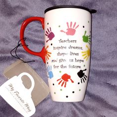 there is a coffee cup with handprints on it next to a tag that says teachers inspire dreams, shape lives and give us hope for the future