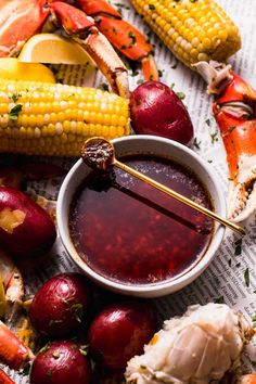 crab legs and corn on the cob with dipping sauce