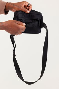 Belt bags are back, baby. We streamlined the ease of a zip closure and buckle strap (with length up to 43”) and added a slot on the back for your phone, plus an interior mesh pocket. Sling it as a crossbody, buckle it around your waist, even strap it on your stroller — nostalgia meets a new, high-function fit in this versatile pouch. Versatile Crossbody Shoulder Strap For Travel, Nylon Belt Bag With Detachable Strap For Travel, Travel Nylon Belt Bag With Detachable Strap, Functional Crossbody Shoulder Bag With Cell Phone Pocket, Functional Shoulder Bag With Detachable Strap For Commuting, Nylon Belt Bag With Adjustable Strap For Everyday Use, Black Crossbody Camera Bag With Zipper Pocket, Functional Camera Shoulder Bag With Mobile Phone Pocket, Nylon Crossbody Belt Bag With Removable Pouch