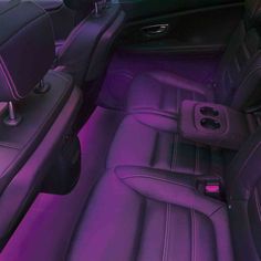 the interior of a car with purple leather seats