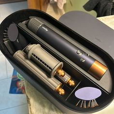 an open case containing two different types of hair dryers