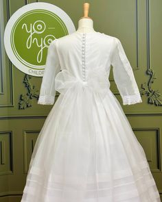 A gorgeous traditional white and long sleeves dress for girls to wear on her communion day. This is a stunning piece made with a white organza and with handmade details throughout the gown; it has pleats, laces, and elegancy. It has buttons and a bow on the back. Made in Spain Does not include crinoline Dry Clean Lining: 100% cotton Final Sale, no exchanges nor returns will be accepted Fitted Gown For Confirmation With Long Sleeves, Fitted Long Sleeve Gown For Confirmation, Long Sleeve Baptism Dress With Ruffles For First Communion, Long Sleeve Ruffled Dress For First Communion, First Communion Dress With Lace Long Sleeves, Elegant First Communion Gown With Lace Sleeves, Long Sleeve Confirmation Dress With Lace Trim, Elegant Gown With Lace Sleeves For First Communion, Elegant Long Sleeve Confirmation Dress