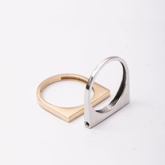 two gold and silver rings on white background