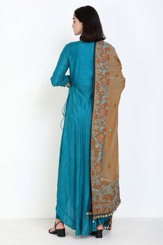 Turquoise angarakha kurta with mirror work and asymmetrical hem. Comes with churidar and embroidered dupatta.
Component: 3
Pattern: Embroidery
Type Of Work: Thread and Mirror
Neckline: V neck
Sleeve Type: Three Fourth
Fabric: Slub Muslin
Color: Blue
Other Details: 
Dupatta with embroidery and tassel detail
Button tabs on the sleeves
Tie up on the side
Occasion: Wedding - Aza Fashions Angarakha Kurta, Muslin Embroidery, Embroidered Dupatta, Pattern Embroidery, Fashion App, Mirror Work, Churidar, Asymmetrical Hem, Set For Women