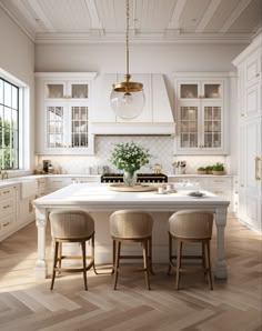 a large kitchen with white cabinets and wooden flooring is pictured in this image, there are three stools at the center of the island