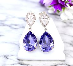 Elegant and Romantic  Tanzanite Teardrop Dangle Earrings! This shade of purple suggests refinement along with grace, elegance and something special.  I made these gorgeous Earrings with: - 18x13mm genuine Tanzanite  teardrop pear shaped fancy stones, set in sterling silver plated settings - Hypoallergenic, Rhodium plated and tarnish resistant .925 Sterling Silver pear shaped ear posts with AAA cubic zirconia stones - these are approx 1 1/4" from top of the ear posts to bottom of the stones These dazzling fancy crystals are designed with incredible facets that produce the famous  sparkle. Perfect for brides, bridesmaids and special occasions! Matching Necklace is available here: https://www.etsy.com/listing/225854945/hot-pink-necklace--crystal-rose Also available in GOLD PLATED finish: http Elegant Lavender Crystal Earrings For Wedding, Purple Teardrop Crystal Earrings For Wedding, Purple Teardrop Crystal Earrings For Formal Occasions, Lavender Crystal Earrings For Wedding, Purple Dangle Teardrop Earrings For Wedding, Lavender Drop Earrings For Formal Occasions, Purple Teardrop Earrings For Wedding, Purple Wedding Teardrop Earrings, Purple Drop Earrings For Wedding