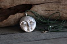 This celestial resting moon face pendant necklace is made by using the ancient lost wax technique, one of the oldest techniques of silversmithing and is hand forged. The moon comes with a sterling silver chain of your choice or a wax cord of your choice. The moon and sun pendant is 20gr solid sterling silver made in great detail. A unique, ethereal and beautiful piece of jewelry that is ideal as a gift to yourself or to someone special. The total length of the cor or chain you choose is 460mm, p Silver Moon-shaped Necklaces For Meditation, Handmade Celestial Necklaces For Meditation, Moon Phase Amulet Necklaces For Meditation, Amulet Style Moon Phase Necklaces For Meditation, Face Pendant, Sun Pendant, Moon Face, Lost Wax, Moon Pendant