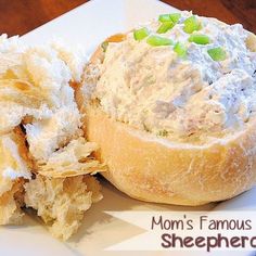 a white plate topped with a bagel covered in cream cheese and green onion chips