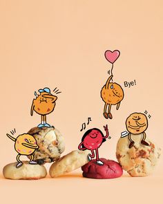 three cookies with cartoon characters on them sitting next to each other and one has a heart shaped balloon above it