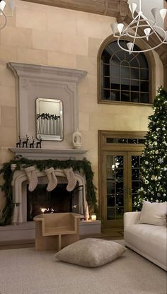 a living room filled with furniture and a christmas tree in front of a fire place