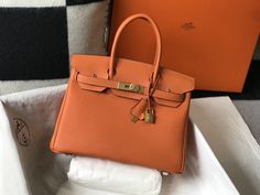 Description HRMS Birkin Orange Togo Gold Hardware Bag For Women, Handbags, Shoulder Bags 30cm/12in Rep 1:1 Size: 30 x 23 x 17 cm / 12 x 9 x 6.5 inches (Length x Height x Width) Hermès bags are considered the ultimate luxury item the world over. Hand stitched by skilled craftsmen, wait lists of a year or more are common. This Birkin has tonal stitching, a front toggle closure, a clochette with lock and two keys, and double rolled handles. This bag is also known to hold the shape of the bag well o Hermes Birkin Orange, Hermes Birkin 30, Togo Leather, Hermes Handbags, Orange Bag, Orange Leather, Hermes Bags, Evening Clutch Bag, Bag For Women