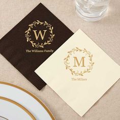 two napkins with the letter m on them are next to a glass and plate