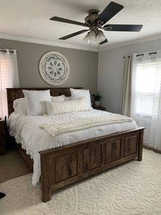 a bedroom with a bed and ceiling fan