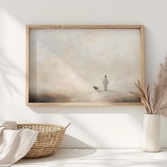 a painting hanging on the wall next to a basket