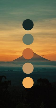 the seven chakras in front of a mountain at sunset