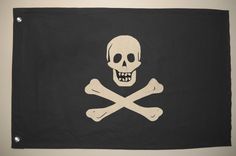 a pirate flag with a skull and crossbones on the front, hanging from a wall