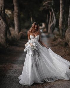 a woman in a wedding dress is walking down the road