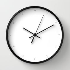 a black and white clock on the wall showing 11 o'clock to 3 o'clock