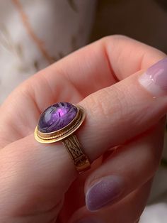 An extremely early Vintage scarab conversion ring with a sensual pink/orchid undertone to the sensual violet color of the stone. Once half of a pair of cufflinks, now a ring, this outstanding conversion has been fitted on a casting of a Victorian striped band. This particular ring is in excellent condition and is perfect for stacking or solo wear with a sizeable stone of 15mm. The ring is a delight to wear and would make a notable addition to any collection. Marks: 14k Age/Origin: Victorian scar Violet Color, Egyptian Revival, Pink Orchids, Cufflinks, Violet, Amethyst, Band, Ring, Stone