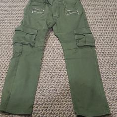 Army Green Cargo Pants. Measurements Are On The Listing Pictures. 38" Long. Unisex Fitted Green Bottoms With Zip Fly, Casual Fitted Pants With Multiple Pockets, Green Tapered Leg Bottoms With Multiple Pockets, Full Length Cotton Bottoms With Zip Fly, Cotton Full Length Bottoms With Zip Fly, Casual Khaki Cargo Pants With Zip Fly, Casual Baggy Cargo Pants With Zip Fly, Casual Khaki Cargo Pants, Fitted Green Cargo Pants With Pockets