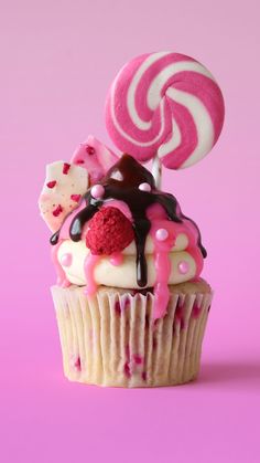 a cupcake decorated with candy and lollipops