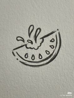 a drawing of a slice of watermelon on a piece of white paper with black ink