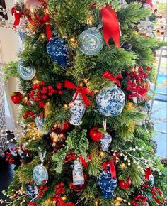 a christmas tree decorated with blue and red ornaments