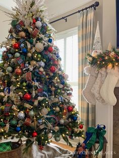 a decorated christmas tree with stockings hanging from it