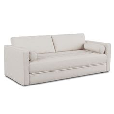 a white couch sitting on top of a wooden floor