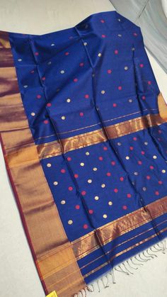 Pure Maheshwari cotton silk saree in blue, with all over buta work, woven design, with a zari border. This traditional saree is very soft, drapes well and goes best with gold earrings. Stitching facility for blouse and falls-zigzag available on demand, at an extra cost Dimensions - 6.2m length, 5.5m saree length with 0.7m blouse piece running material. Best quality Blue Saree With Traditional Patterns For Festivals, Blue Chanderi Dupatta For Diwali, Blue Handloom Traditional Silk Wear, Blue Handloom Paithani Silk Traditional Wear, Blue Anarkali Handloom Saree, Blue Chanderi Dupatta For Festivals, Blue Handloom Traditional Wear For Festive Occasions, Festive Blue Handloom Traditional Wear, Blue Art Silk Dupatta For Puja