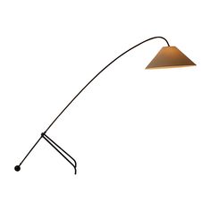 a floor lamp that is on top of a white wall and has a black base