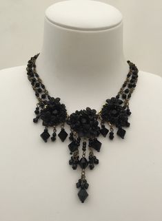 Beautiful black necklace in Black Beauty. Jet black glass beads sewn together with hand painted resin flowers and handmade polymer clay flowers. Three clusters of pretty black flowers with drops and a handbead necklace with jet beads. Simply classic black that can be worn anywhere. This is a quality piece of jewelry that will last a life time. Created by designer Colleen Toland who has been creating her unique style of vintage jewelry for more than 30 years. All of our pieces come with an engrav Handmade Black Czech Glass Necklaces, Handmade Black Czech Glass Necklace, Handmade Black Necklace With Czech Glass, Adjustable Black Jewelry With Bead Caps, Vintage Black Handmade Beaded Necklaces, Beauty Necklace, Painted Resin, Bead Sewing, Polymer Clay Flowers