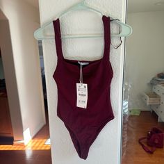 Nwt. Ribbed Stretchy Material. Maroon/Red Bodysuit From Zara Red Fitted Cotton Bodysuit, Black Ribbed Top, Metallic Crop Top, Lace Turtleneck, Blue Halter Top, Floral Print Crop Top, Red Bodysuit, Zara Crop Top, Zara Blouse