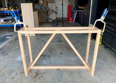 a workbench made out of plywood and wooden planks in a garage