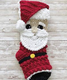 a crocheted christmas stocking with a santa clause on it's face